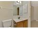 Bathroom featuring a single vanity with a marble countertop, toilet, and medicine cabinet at 5641 Mashie Cir, North Port, FL 34287