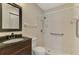 Bathroom featuring a single vanity, toilet, and accessible shower with safety bars at 5641 Mashie Cir, North Port, FL 34287