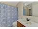 Bathroom featuring a vanity with a marble countertop, toilet, and tub with a floral shower curtain at 5641 Mashie Cir, North Port, FL 34287