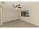 Bedroom showcasing neutral carpet, a ceiling fan, and natural light from a window at 5641 Mashie Cir, North Port, FL 34287