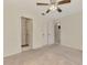 Bright bedroom with neutral carpet and an open doorway to a bathroom and hall at 5641 Mashie Cir, North Port, FL 34287