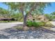 Well-maintained landscaping surrounds the property with mature trees and lush greenery at 5641 Mashie Cir, North Port, FL 34287