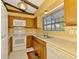 Bright kitchen featuring wooden cabinets, window, appliances, tile floor, and an eat-in area at 5641 Mashie Cir, North Port, FL 34287