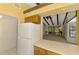 Kitchen view into living room featuring tile floors and wooden beams overhead at 5641 Mashie Cir, North Port, FL 34287