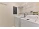 Laundry room featuring a washer and dryer with wire shelves and overhead lighting at 5641 Mashie Cir, North Port, FL 34287