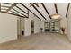 Inviting living room with exposed beams, offering access to other rooms and a screened porch at 5641 Mashie Cir, North Port, FL 34287