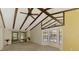 Bright living room with vaulted ceilings, exposed beams, and a bay window at 5641 Mashie Cir, North Port, FL 34287