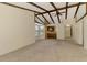 Bright and airy living room with exposed beams, providing access to the kitchen at 5641 Mashie Cir, North Port, FL 34287