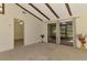 Living room with exposed beams and view of the screened patio at 5641 Mashie Cir, North Port, FL 34287