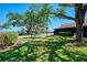 Lush green yard featuring mature trees and landscaping, creating a tranquil setting at 5641 Mashie Cir, North Port, FL 34287