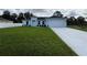 Charming single-story home featuring a two-car garage and well-manicured lawn at 6274 Skyview Dr, North Port, FL 34291