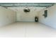 Spacious and well-lit garage with a clean, painted floor, ample storage space, and utility connections at 6274 Skyview Dr, North Port, FL 34291
