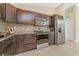 Modern kitchen with stainless steel appliances, granite countertops, and dark wood cabinets at 6274 Skyview Dr, North Port, FL 34291