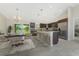 Modern kitchen with dark wood cabinets, stainless appliances, large island, and backyard views at 6274 Skyview Dr, North Port, FL 34291