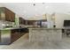 A spacious kitchen featuring dark wood cabinets and tile backsplash at 6274 Skyview Dr, North Port, FL 34291