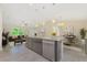 Open floor plan featuring a kitchen island with stone countertops, stainless steel appliances, and pendant lighting at 6274 Skyview Dr, North Port, FL 34291