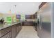 Bright kitchen featuring dark wood cabinets, granite countertops, and stainless appliances at 6274 Skyview Dr, North Port, FL 34291
