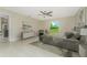 Relaxing main bedroom featuring neutral tones, natural light, tile flooring, and a ceiling fan at 6274 Skyview Dr, North Port, FL 34291