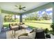 Charming covered patio boasts comfortable seating and a picturesque view of the lush backyard and sky at 6274 Skyview Dr, North Port, FL 34291