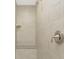 Modern bathroom with a tiled walk-in shower featuring a shower bench and a shower head at 6274 Skyview Dr, North Port, FL 34291