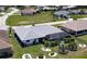 Aerial view of a single-Gathering home with a screened-in pool, fenced yard, and manicured landscaping at 7148 N Blue Sage, Punta Gorda, FL 33955