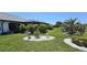 Lush backyard featuring manicured landscaping, a screened-in lanai, and well-maintained lawn at 7148 N Blue Sage, Punta Gorda, FL 33955