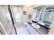 Bright bathroom featuring white tile floors, a shower, and vanity with sink at 7148 N Blue Sage, Punta Gorda, FL 33955