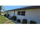Exterior side view of white siding, window with shade and AC unit at 7148 N Blue Sage, Punta Gorda, FL 33955