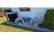 Exterior side view of AC and stacked lounge chairs on stone bed at 7148 N Blue Sage, Punta Gorda, FL 33955