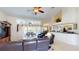 Open concept living room with high ceilings, leather furniture, and access to the outdoor pool area at 7148 N Blue Sage, Punta Gorda, FL 33955