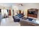 Cozy living room featuring leather furniture, tiled flooring, and views of the dining area and entrance at 7148 N Blue Sage, Punta Gorda, FL 33955