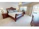 Spacious main bedroom with neutral colors, a ceiling fan, and access to the lanai at 7148 N Blue Sage, Punta Gorda, FL 33955