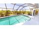 Screened-in pool with crystal-clear water surrounded by lush landscaping at 7148 N Blue Sage, Punta Gorda, FL 33955