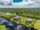 Beautiful aerial view of a waterfront home and manicured lawn on a sunny day at 1025 Cheshire St, Port Charlotte, FL 33953