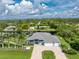 Wonderful aerial view of the landscaped yard of a home with a three-car garage, with backyard access to the water at 1025 Cheshire St, Port Charlotte, FL 33953