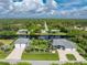 A serene aerial shot of a waterfront home, highlighting its manicured lawn and tranquil surroundings at 1025 Cheshire St, Port Charlotte, FL 33953
