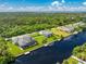 Aerial view showcasing a waterfront home with a screened pool and private boat dock at 1025 Cheshire St, Port Charlotte, FL 33953