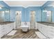 Bright bathroom with dual vanities, standalone tub, and glass showers at 1025 Cheshire St, Port Charlotte, FL 33953