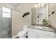 Bathroom featuring a granite vanity top and a glass-enclosed shower with marble-like tile at 1025 Cheshire St, Port Charlotte, FL 33953