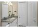 Bathroom featuring a granite vanity top and a large mirror at 1025 Cheshire St, Port Charlotte, FL 33953