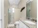Bathroom featuring a granite vanity top and a glass-enclosed shower with marble-like tile at 1025 Cheshire St, Port Charlotte, FL 33953