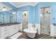This spacious bathroom features a soaking tub, double showers, granite counters, and modern fixtures at 1025 Cheshire St, Port Charlotte, FL 33953