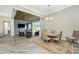 Open-concept dining area featuring wood floors, access to outdoor living space, and natural light at 1025 Cheshire St, Port Charlotte, FL 33953