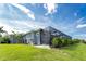 Exterior view of the home's side and screened-in pool area from the backyard at 1025 Cheshire St, Port Charlotte, FL 33953