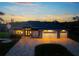 Beautifully landscaped home features a paver driveway, three car garage, and a meticulously maintained yard at 1025 Cheshire St, Port Charlotte, FL 33953