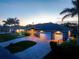 The home features mature palms, a paver drive, and a sprawling front lawn at 1025 Cheshire St, Port Charlotte, FL 33953