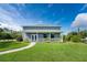 Charming home with a well-manicured lawn, complemented by beautiful landscaping and a welcoming front porch at 1025 Cheshire St, Port Charlotte, FL 33953