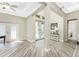 Elegant foyer with wood-look tile flooring, decorative double doors, and views into the home at 1025 Cheshire St, Port Charlotte, FL 33953