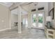 Bright foyer featuring wood-look tile flooring, stylish double doors, and an open floor plan at 1025 Cheshire St, Port Charlotte, FL 33953