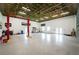 Large garage featuring an open, unfinished ceiling, epoxy floors, and ample space for workshop equipment and storage at 1025 Cheshire St, Port Charlotte, FL 33953